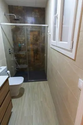 a bathroom with a shower with a toilet and a sink at SH Casa Candelaria. Apartamento en el centro. in Cádiz