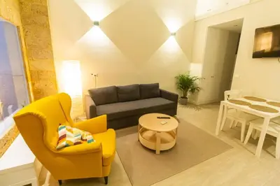 a living room with a couch and chairs and a table at SH Casa Candelaria. Apartamento en el centro. in Cádiz