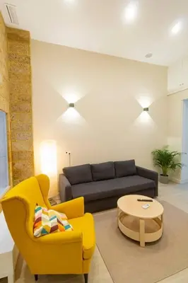 a living room with a couch and a table at SH Casa Candelaria. Apartamento en el centro. in Cádiz