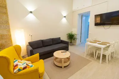 a living room with a couch and a table at SH Casa Candelaria. Apartamento en el centro. in Cádiz