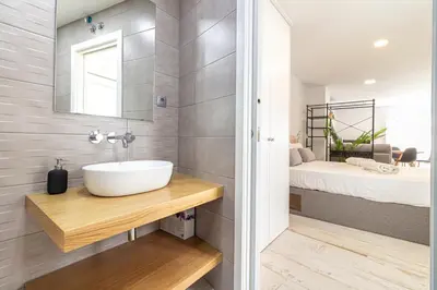 a bathroom with a sink and a bed at Allo Apartments San Roque Bajo B in Cádiz