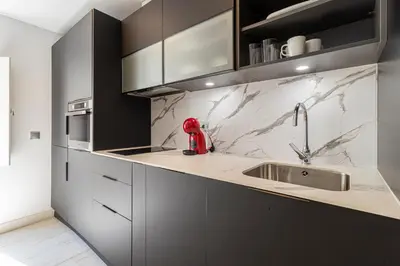 a kitchen with a sink and a red appliance on the counter at Allo Apartments San Roque Bajo B in Cádiz