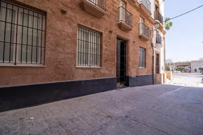 an empty street in front of a brick building at Allo Apartments San Roque Bajo B in Cádiz