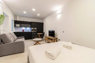 a bedroom with a bed and a living room at Allo Apartments San Roque Bajo C in Cádiz