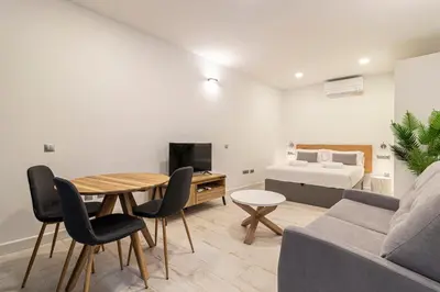 a living room with a couch and a table and a bed at Allo Apartments San Roque Bajo C in Cádiz