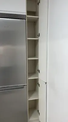 a kitchen with white cabinets and a refrigerator at Piso de lujo en primera linea de playa y garaje in Cádiz