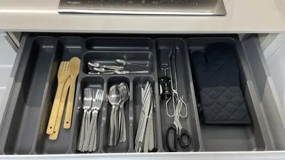 a drawer filled with silver utensils in a drawer at Piso de lujo en primera linea de playa y garaje in Cádiz