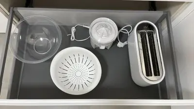 a shelf with two dishes and a hair dryer and glasses at Piso de lujo en primera linea de playa y garaje in Cádiz