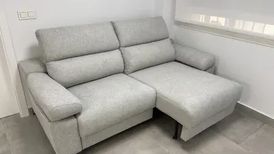 a gray couch in a room with a window at Piso de lujo en primera linea de playa y garaje in Cádiz