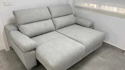 a gray couch in a room with a window at Piso de lujo en primera linea de playa y garaje in Cádiz