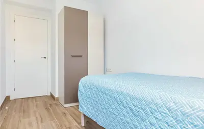 a white bedroom with a bed and a closet at 3 Bedroom Amazing Apartment In Cadiz in Cádiz