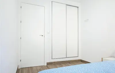 a bedroom with white walls and two closets at 3 Bedroom Amazing Apartment In Cadiz in Cádiz
