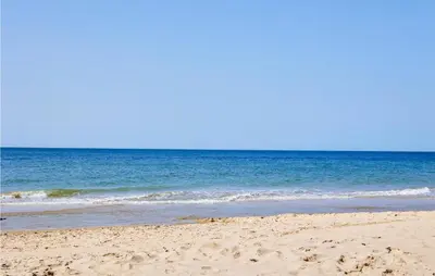 a sandy beach with the ocean in the background at 3 Bedroom Amazing Apartment In Cadiz in Cádiz