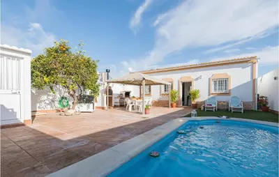 a backyard with a swimming pool and a house at Stunning Home In San Jose Del Valle in San Jose del Valle
