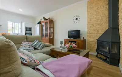 a living room with a couch and a fireplace at Stunning Home In San Jose Del Valle in San Jose del Valle