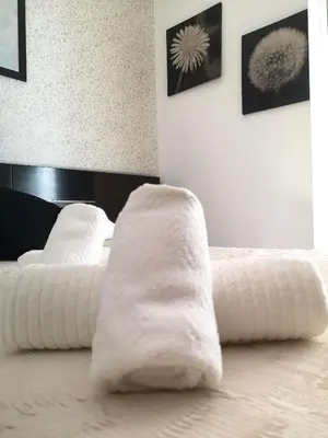 a white bed with two white pillows on it at La Casita del Arte in Cádiz