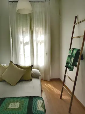 a bedroom with a bunk bed and a ladder at La Casita del Arte in Cádiz