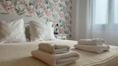 a bed with towels on top of it with at Colón Corazón de Cádiz con Ascensor Grupo AC Gestion in Cádiz