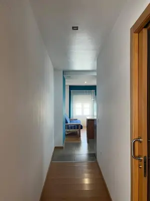 a hallway leading to a living room with a couch at Colón Corazón de Cádiz con Ascensor Grupo AC Gestion in Cádiz