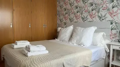 a bedroom with a bed with towels on it at Colón Corazón de Cádiz con Ascensor Grupo AC Gestion in Cádiz