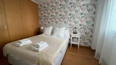 a bedroom with two towels on a bed at Colón Corazón de Cádiz con Ascensor Grupo AC Gestion in Cádiz