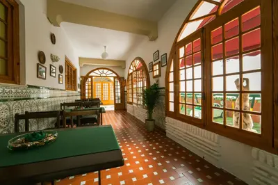 a dining room with a table and some windows at Hotel Regio 2 in Cádiz