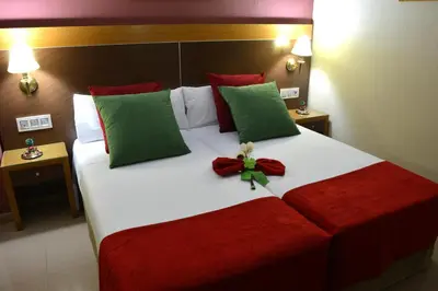 a bed with a teddy bear sitting on top of it at Hotel Regio 2 in Cádiz