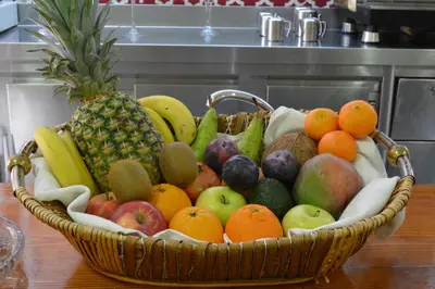 a basket of fruit sitting on a table at Hotel Regio 2 in Cádiz