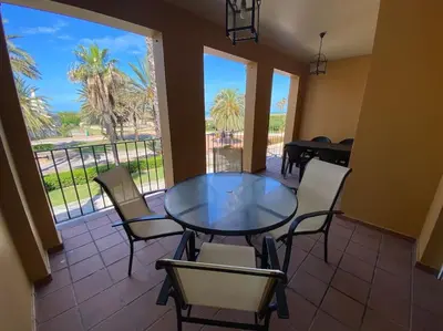 a dining room with a glass table and chairs at Villa palacio Playa y piscina Grupo AC Gestion in Cádiz
