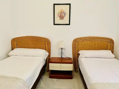 two beds sitting next to each other in a room at Villa palacio Playa y piscina Grupo AC Gestion in Cádiz