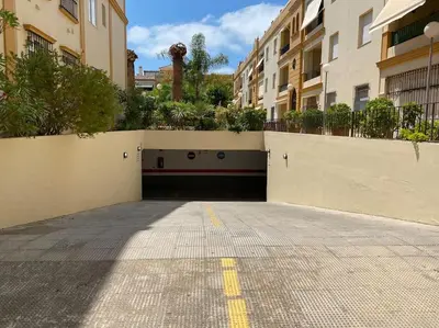 an empty parking lot in a building with buildings at Villa palacio Playa y piscina Grupo AC Gestion in Cádiz
