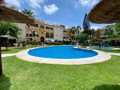 a large blue pool in the middle of a yard at Villa palacio Playa y piscina Grupo AC Gestion in Cádiz