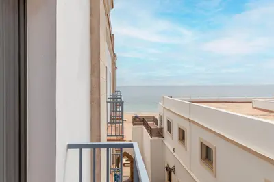 a view of the beach from a balcony of a building at Hotel Duque de Najera in Rota