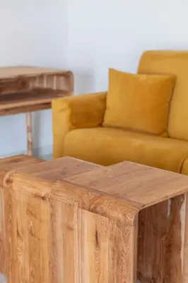 a wooden stump coffee table in front of a couch at Hotel Duque de Najera in Rota