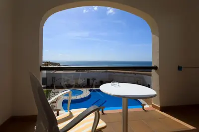 a balcony with a table and a view of the ocean at Hotel Duque de Najera in Rota