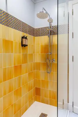 a bathroom with a shower with orange tiles at Hotel Duque de Najera in Rota