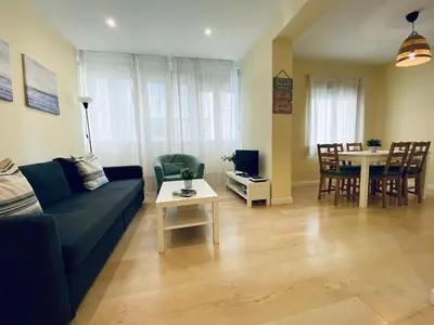 a living room with a couch and a table at Bright Beach House Grupo AC Gestion in Cádiz