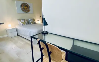 a bedroom with a bed and a glass railing at Bright Beach House Grupo AC Gestion in Cádiz