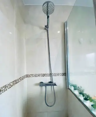 a shower with a shower head in a bathroom at Bright Beach House Grupo AC Gestion in Cádiz