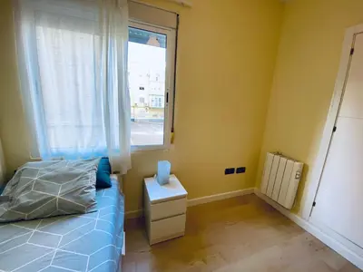 a bedroom with a bed and a window at Bright Beach House Grupo AC Gestion in Cádiz