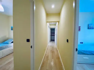 an empty room with a hallway leading to a bedroom at Bright Beach House Grupo AC Gestion in Cádiz