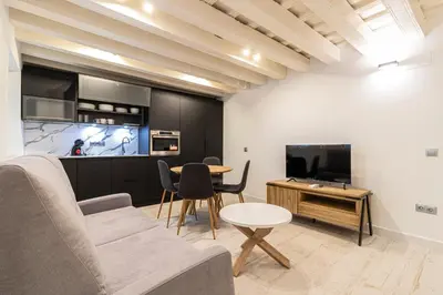 a living room with a couch and a table and a tv at Allo Apartments San Roque 1ºC in Cádiz