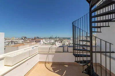a balcony with a spiral staircase on a building at Allo Apartments San Roque 2ºA in Cádiz