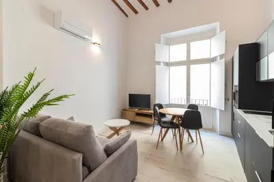 a living room with a couch and a table at Allo Apartments San Roque 2ºB in Cádiz