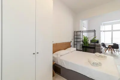a bedroom with a bed with two towels on it at Allo Apartments San Roque 2ºB in Cádiz