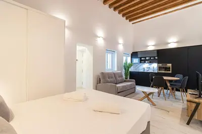 a kitchen and living room with a table and chairs at Allo Apartments San Roque 2ºC in Cádiz