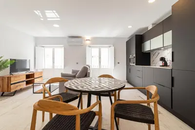 a kitchen and living room with a table and chairs at Allo Apartments San Roque 3ºA in Cádiz
