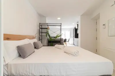 a bedroom with a large white bed with two pillows at Allo Apartments San Roque 3ºB in Cádiz