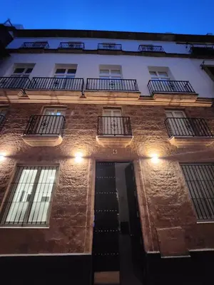 a brick building with windows and a stairway at Allo Apartments San Roque 3ºC in Cádiz