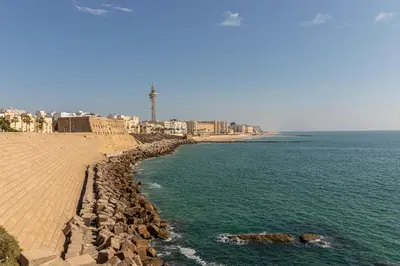 a view of the ocean with a beach and buildings at Allo Apartments San Roque 3ºC in Cádiz